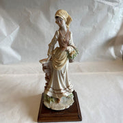 Capodimonte Lady with Basket By a Brick Wall